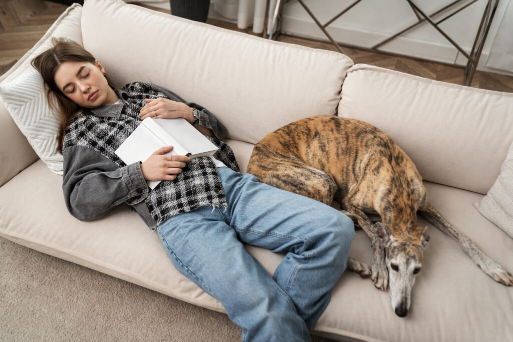 high-angle-woman-dog-sleeping-couch