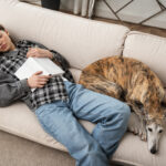 high-angle-woman-dog-sleeping-couch